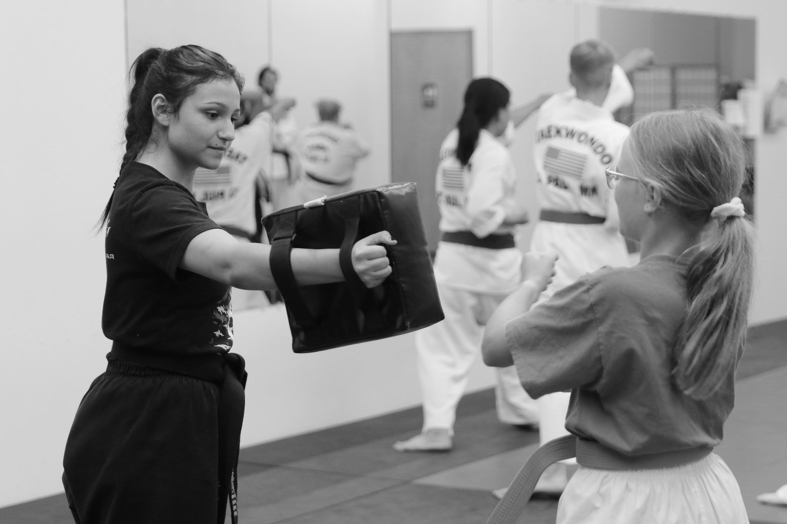 Instructor at Legacy Martial Arts teaching a student 