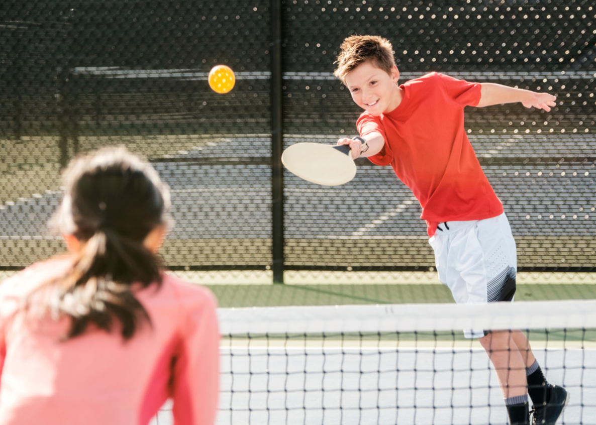 Image of Kids Playing Pickleball outdoors