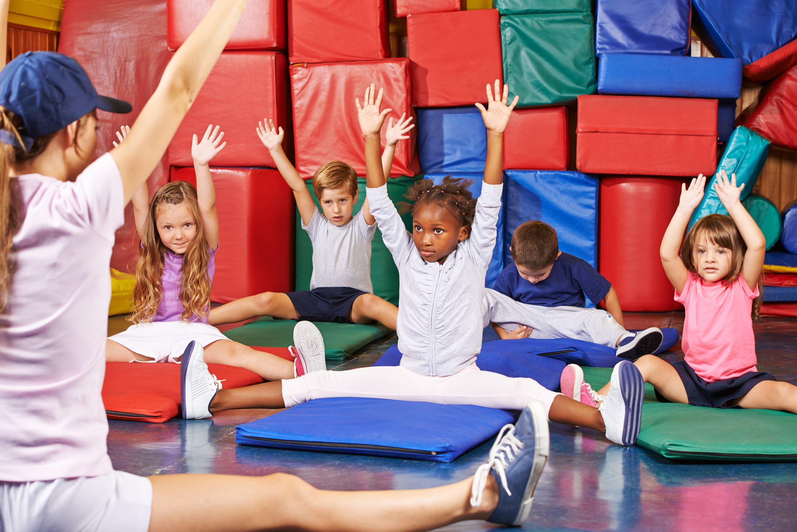 Gymnastics instructor teaching kids